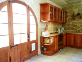 Razzett BALLUTA kitchen with door leading to pool area